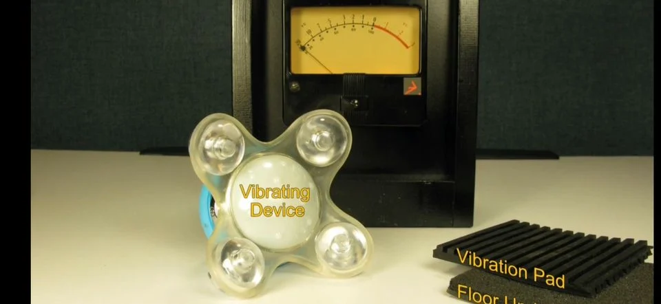Vibration control demonstration showing VU meter, vibrating device, vibration pad, and floor underlayment